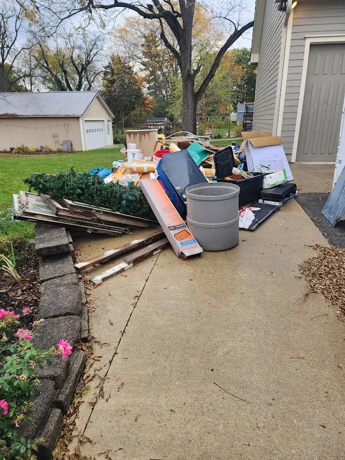 Dumpster being loaded with debris for Commercial Dumpster Rental in Wheat Ridge